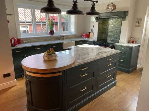 In-frame shaker-style kitchen painted deep forest green and shell