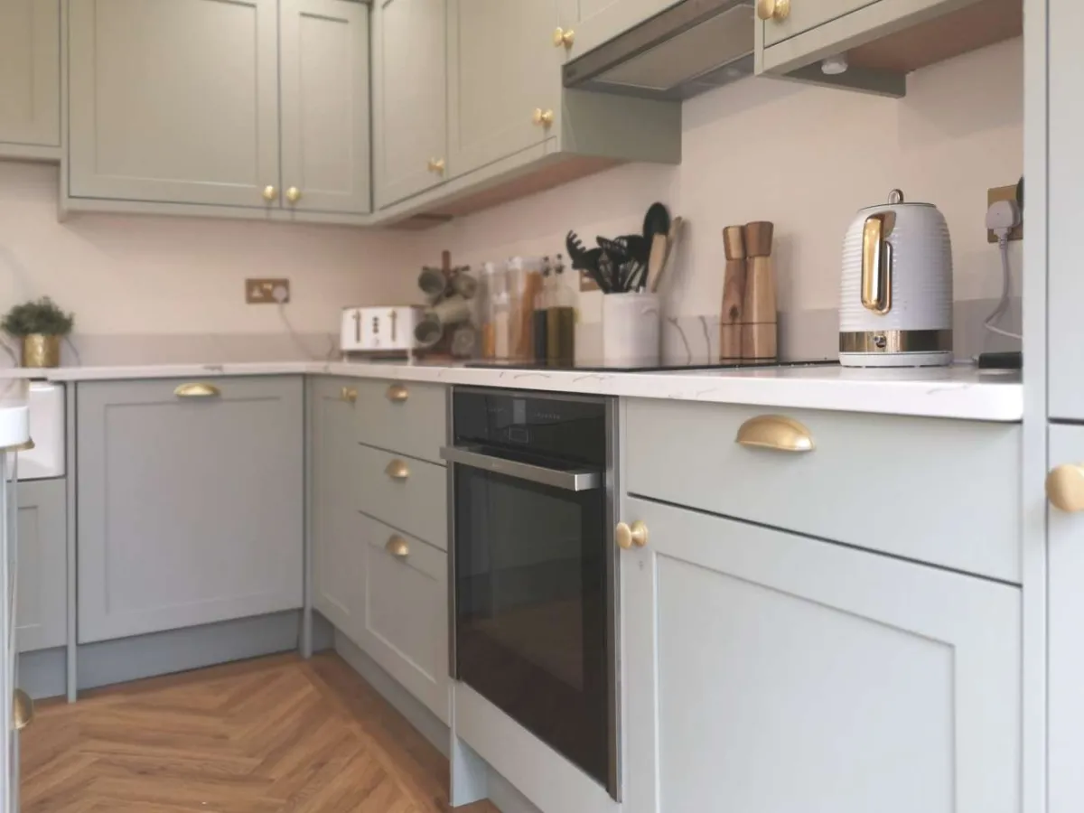 Contemporary shaker-style kitchen with oven housing painted sage green