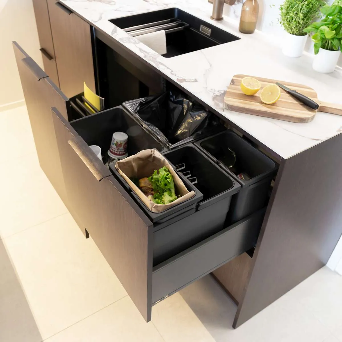 Modern style Puustelli Miinus kitchen showing recycling centre