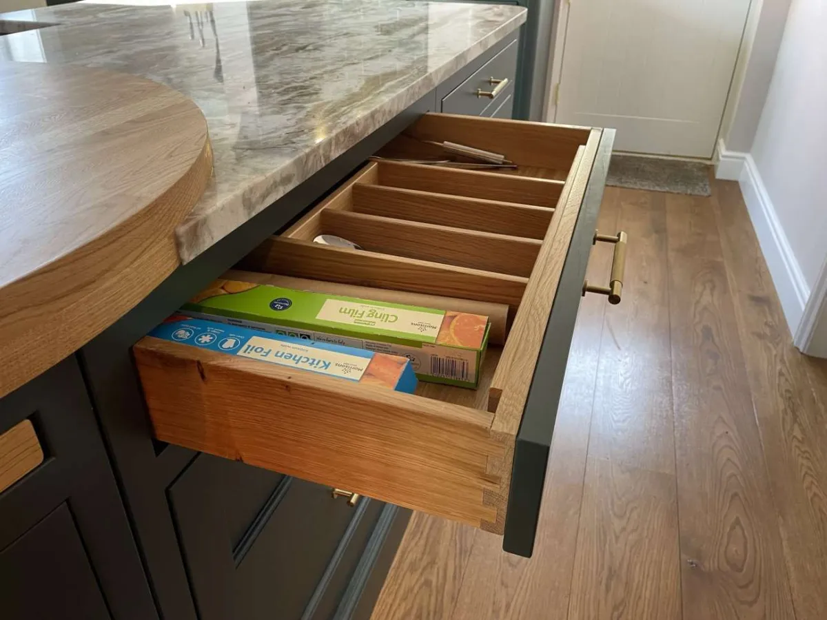 In-frame shaker style kitchen island with pull-out drawer in oak finish