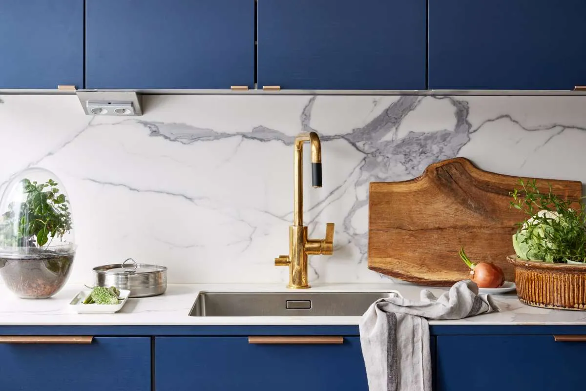 Modern style blue kitchen showing ceramic marble splashback