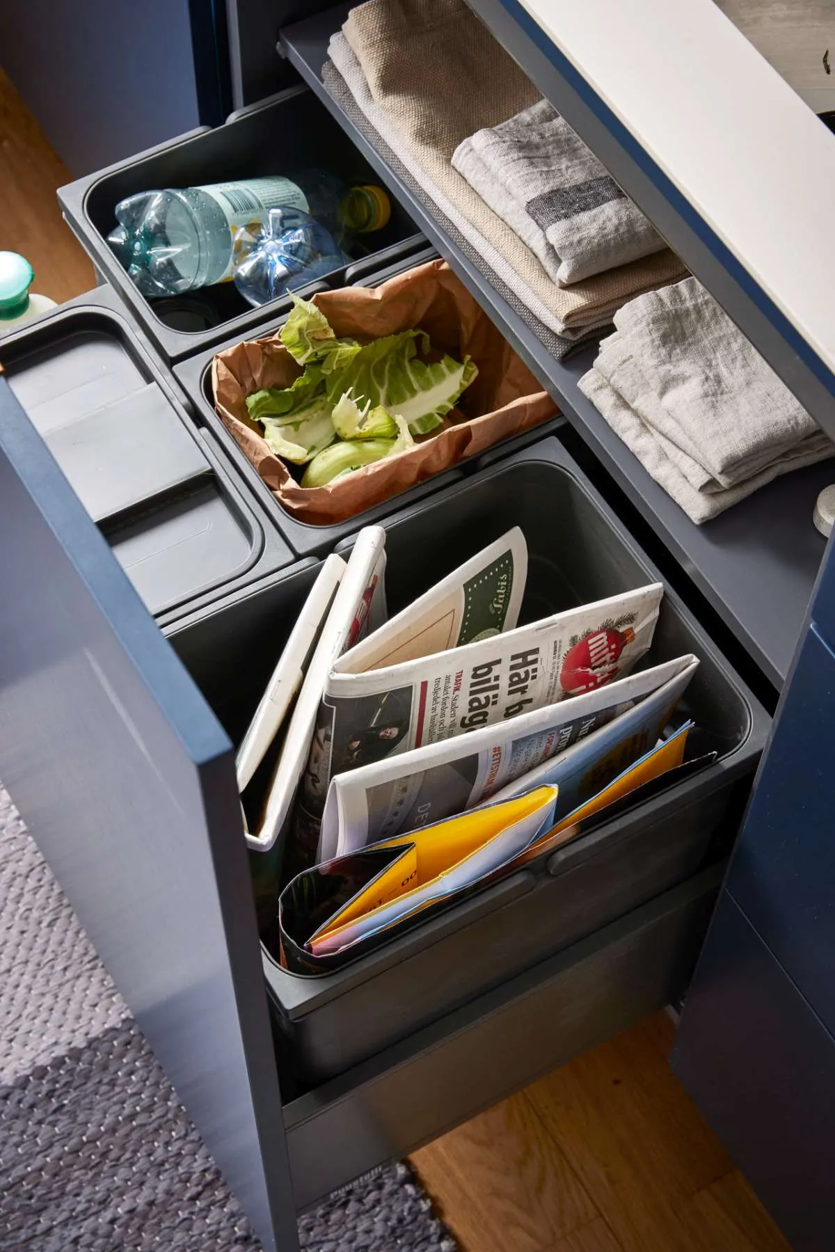 Modern style kitchen showing recycle centre under sink