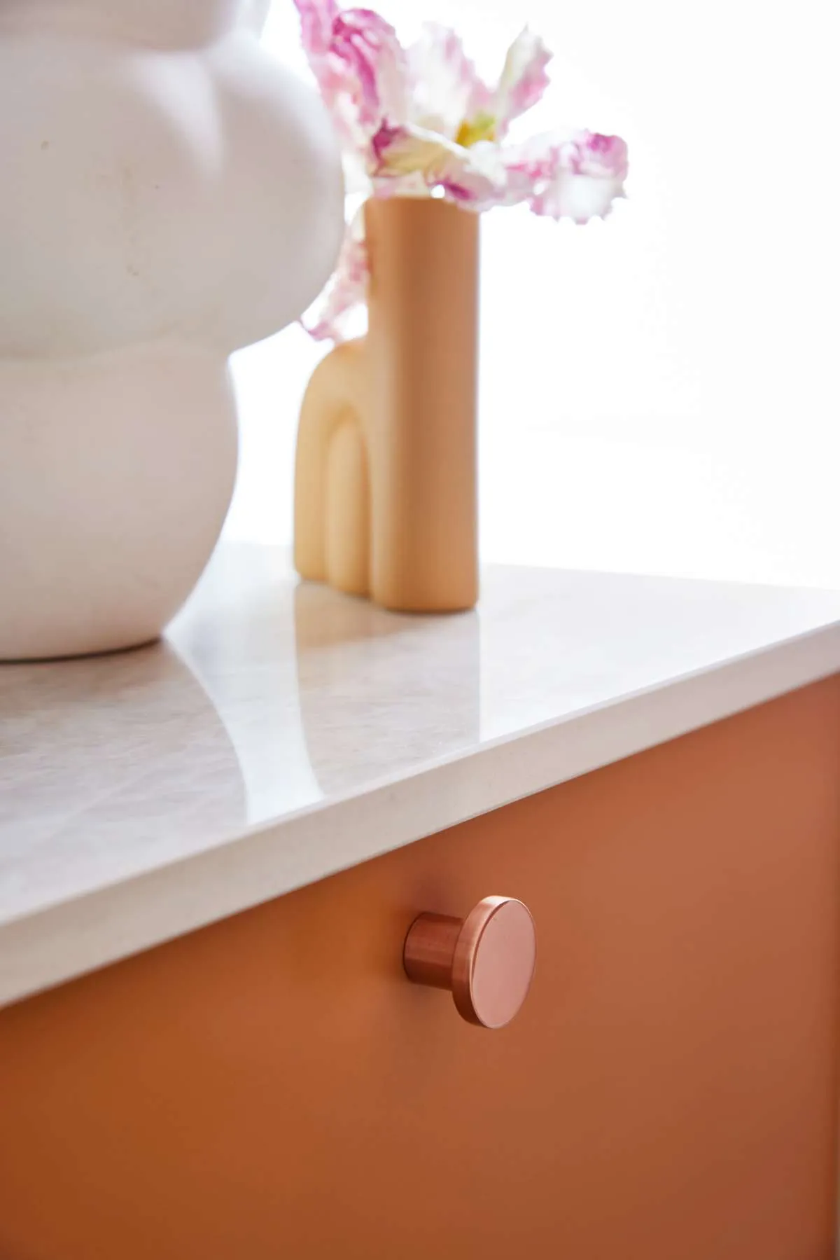 Modern style kitchen showing terracotta front with ceramic worktop