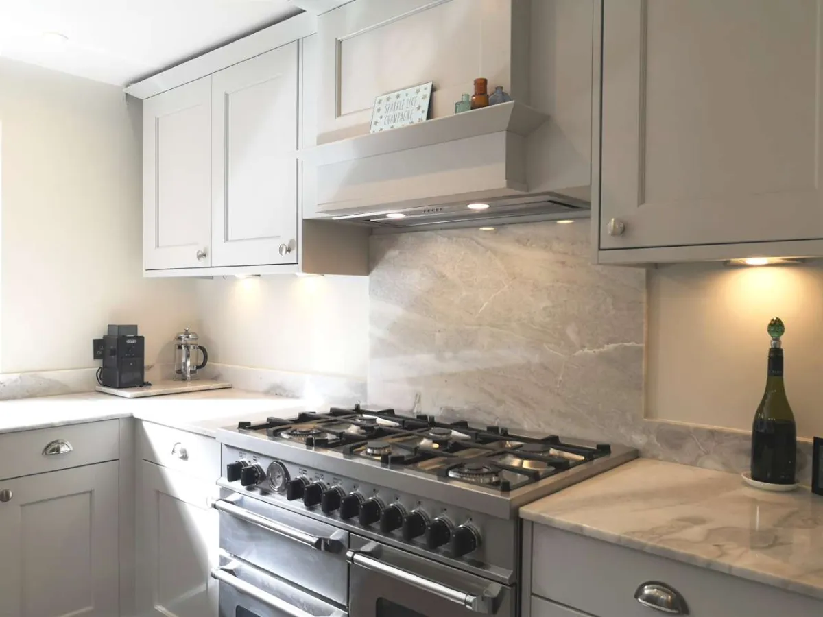 Traditional shaker style kitchen painted light grey showing range cooker